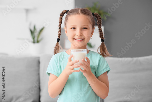 Cute little girl with glass...