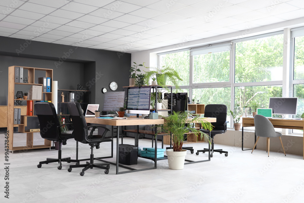 Fototapeta premium Interior of programmer's office with desks and plants
