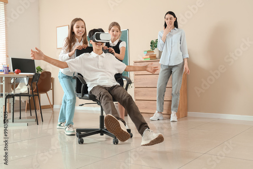 Teenage boy using VR glasse...