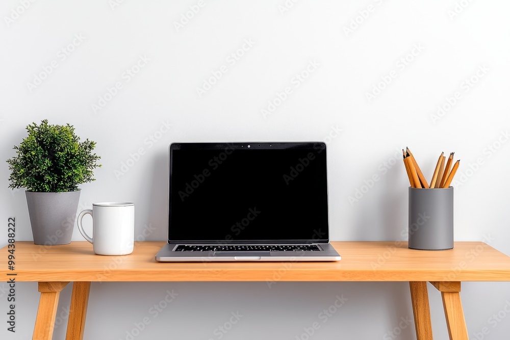 A minimalist desk with a laptop and coffee mug, set against a white wall with nothing but essentials for work A minimalist desk with a laptop and coffee mug, set against a white wall with nothing but essentials for work