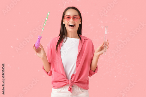 Young woman with soap bubbl...