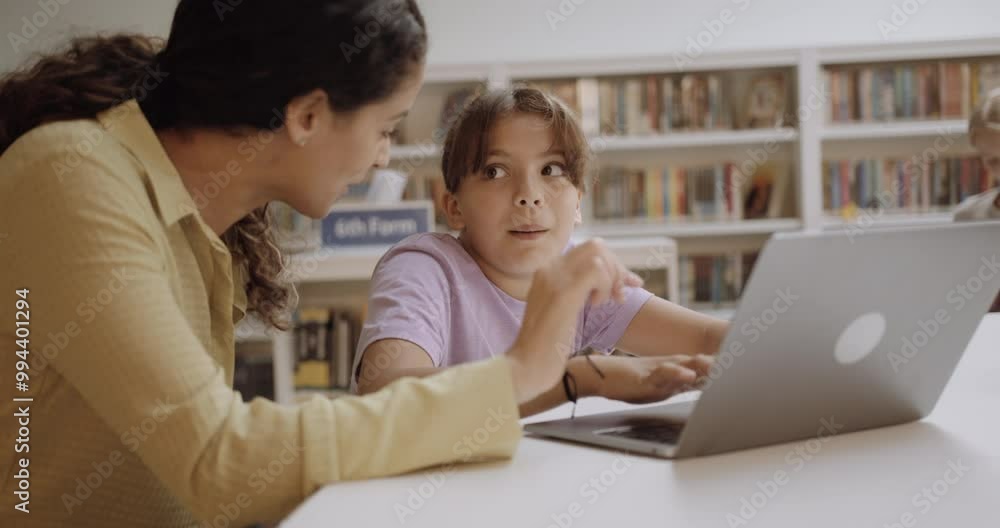 Teacher with School Child in Education Library using Laptop Technology Teacher with School Child in Education Library using Laptop Technology