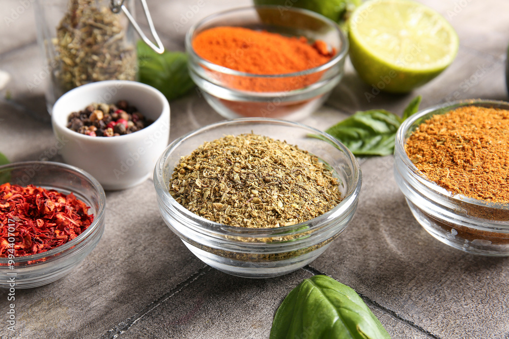 Bowls of different spices on grunge tile table Bowls of different spices on grunge tile table