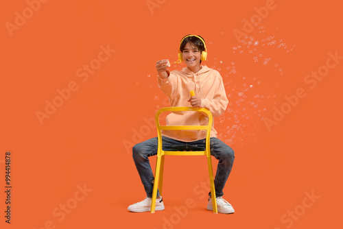Teenage boy in headphones w...