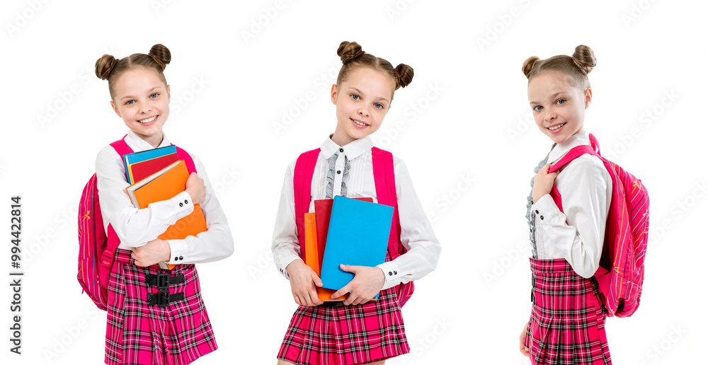 Fototapeta premium Happy cute child girl in school uniform holding books.