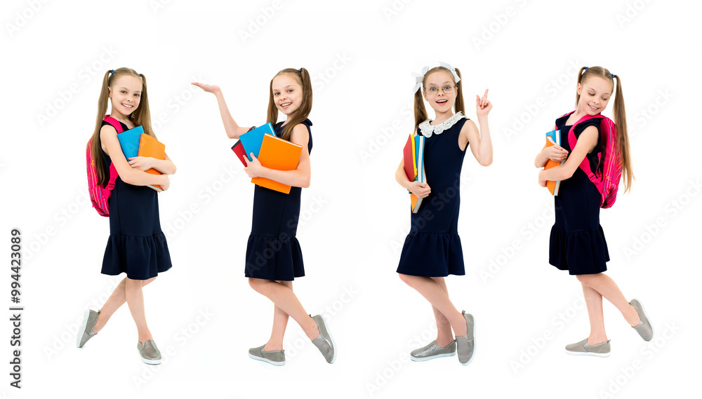 Happy cute child girl in school uniform holding books. Happy cute child girl in school uniform holding books.