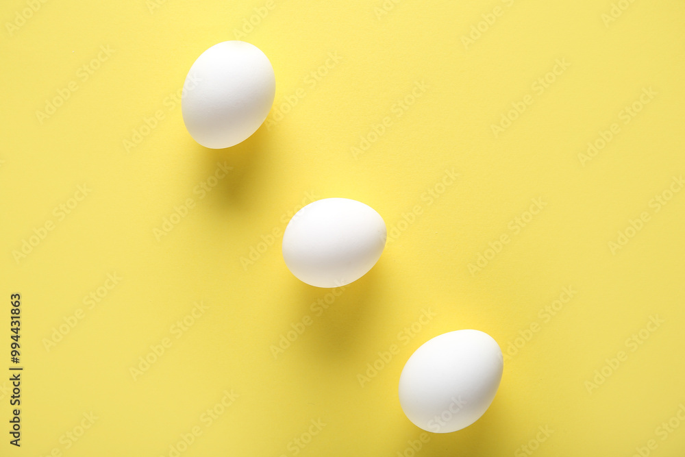 Raw chicken eggs on yellow background Raw chicken eggs on yellow background