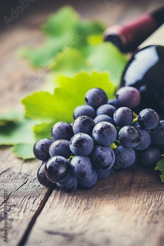 Freshly harvested grapes and red wine on rustic wooden table ready for tastin...