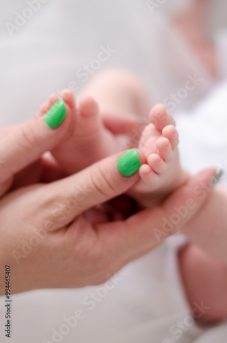 Mother hands with baby foot