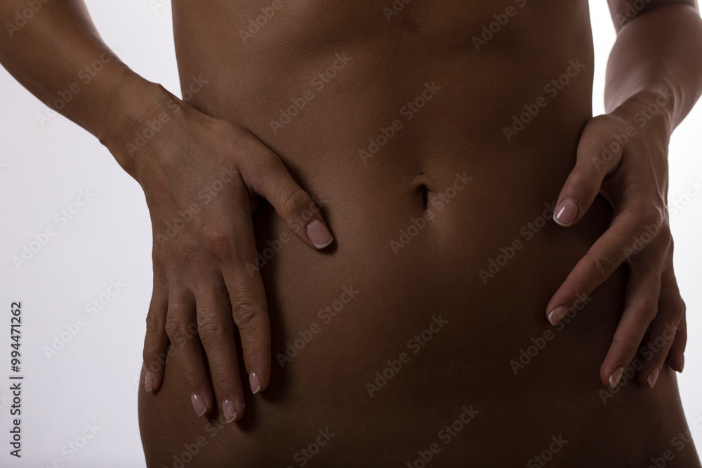 Cropped image of slim female body. Sensual. Woman body belly. Sensual. Photo. Model. Background. Cropped image of slim female body. Sensual. Woman body belly. Sensual. Photo. Model. Background.