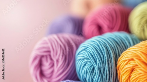 Colorful skeins of yarn stacked together in vibrant shades for crafting proje...
