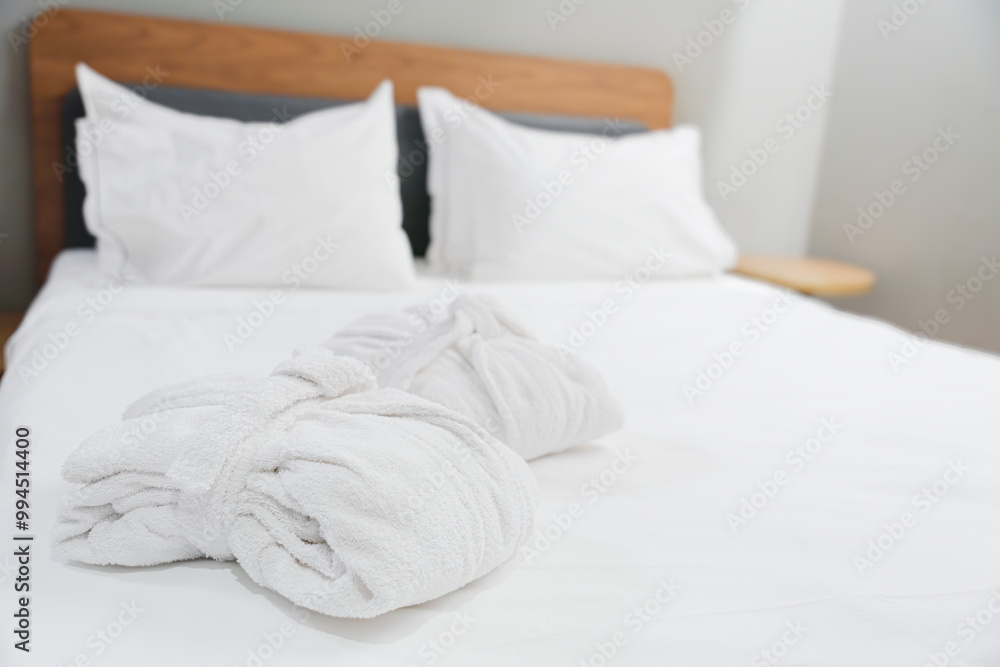 Folded Terry Robes On Bed With White Linens Folded Terry Robes On Bed With White Linens