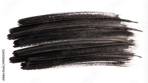 Black paint is applied with a brush on a white background