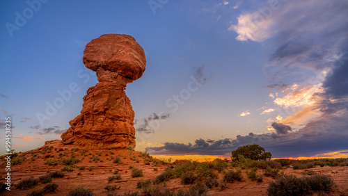Sunset over Balanced Rock in Arches National Park. Arches National Park, located in southeastern Utah, USA. This rock formation is one of the most popular attractions in the park