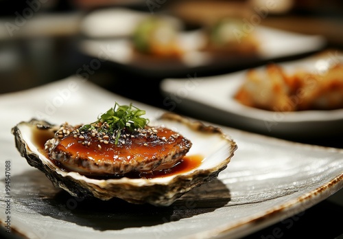 Close-up of avalons served on a white rectangular plate at a Jeju Island restaurant. photo