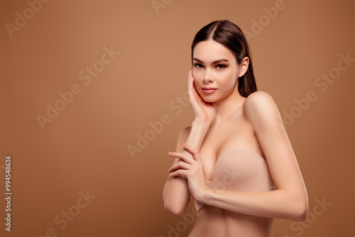 Photo of pretty stunning lady wear nothing arm touching cheek smiling empty space isolated brown color background