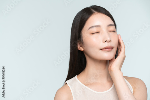 Skin care. Woman with beauty face touching healthy facial skin portrait. Asian woman. 