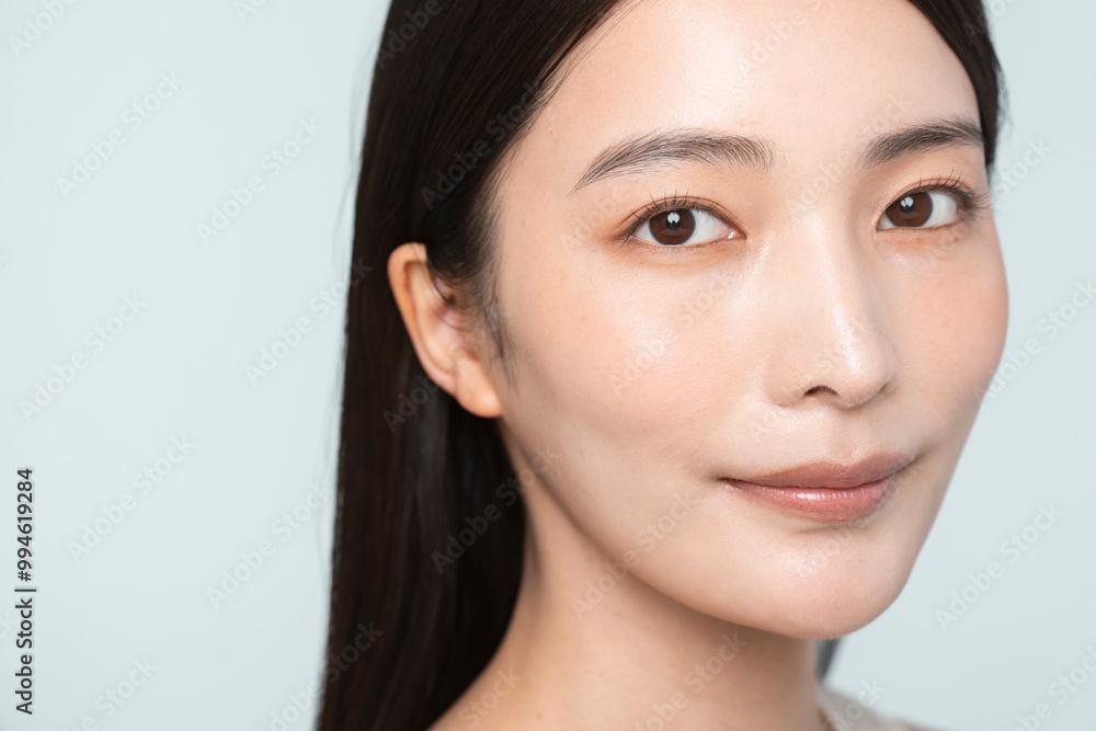 Portrait of a young beautiful Asian woman. She has straight black hair. Portrait of a young beautiful Asian woman. She has straight black hair.