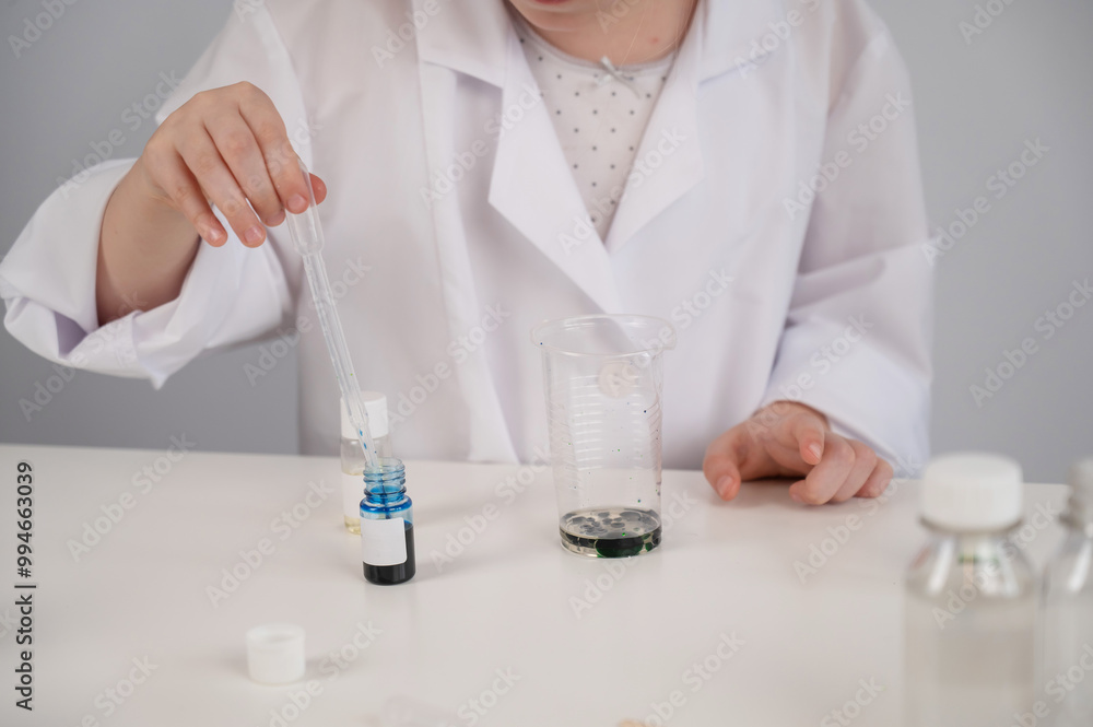 Faceless girl doing chemical experiments on a white background. Faceless girl doing chemical experiments on a white background.