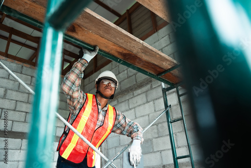 An engineer inspects construction operations and assesses the structural integrity of a house. This process ensures safety and adherence to building standards.