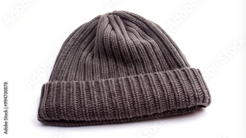 Dark grey knitted wool hat is laying on a white background