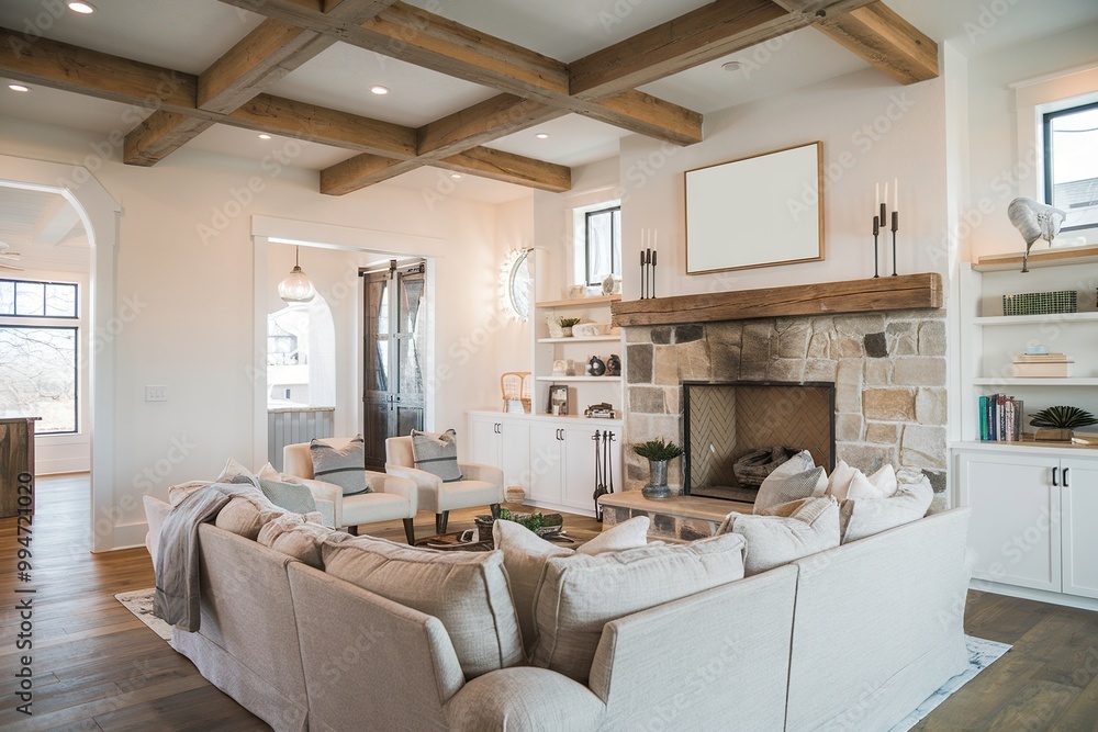 A warm and inviting modern farmhouse living room featuring rustic wood beams and a small framed plain white canvas. Neutral tones and cozy decor complete the look. A warm and inviting modern farmhouse living room featuring rustic wood beams and a small framed plain white canvas. Neutral tones and cozy decor complete the look.