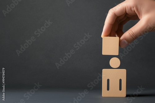 Hand Shaping a Person Figure from Blocks, Representing Career Development and Recruitment Strategies