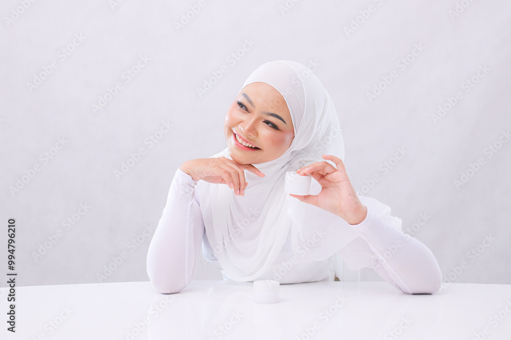 Charm Beautiful adult woman laughing look right hand touch chin and hold cosmetic cream in front of head to show skin care products with white background. commercial, health, medical and fashion Charm Beautiful adult woman laughing look right hand touch chin and hold cosmetic cream in front of head to show skin care products with white background. commercial, health, medical and fashion