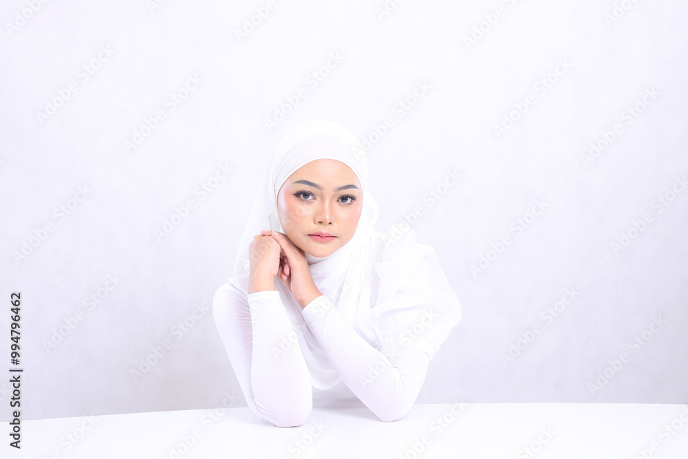 portrait charm Young woman hijab beautiful elegant look at camera hands on white table and parallel clenched isolated white background. concept cosmetics, health, skin care, Facial treatment portrait charm Young woman hijab beautiful elegant look at camera hands on white table and parallel clenched isolated white background. concept cosmetics, health, skin care, Facial treatment