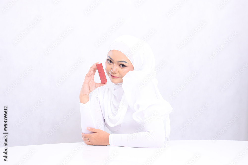Beautiful hijab young girl asia lip makeup view smile look at camera hand holding lipstick container and sticking elbow isolated white background. beauty education concept, lipstick mock up container Beautiful hijab young girl asia lip makeup view smile look at camera hand holding lipstick container and sticking elbow isolated white background. beauty education concept, lipstick mock up container