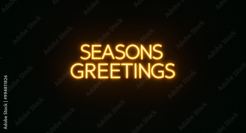 seasons greetings word lettering with yellow glow on plain black dark background seasons greetings word lettering with yellow glow on plain black dark background