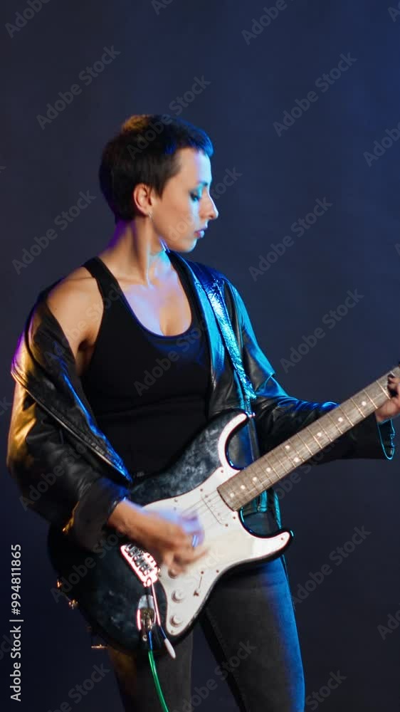 Vertical video Female rock musician dealing with a painful headache while performing, feeling unwell and worried about her sickness. Artist rocker singing in discomfort from the migraine. Camera B. Vertical video Female rock musician dealing with a painful headache while performing, feeling unwell and worried about her sickness. Artist rocker singing in discomfort from the migraine. Camera B.