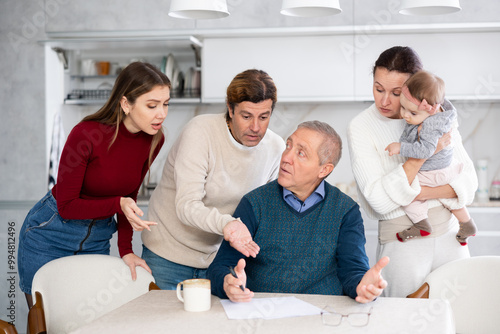 Family members giving advice to old man and discussing inheritance photo