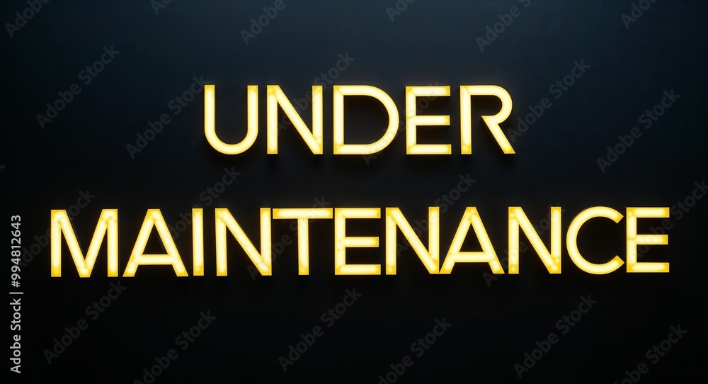 under maintenance word lettering with yellow glow on plain black dark background under maintenance word lettering with yellow glow on plain black dark background