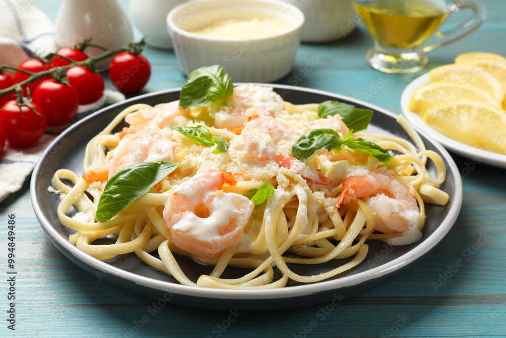 Tasty pasta with shrimps on light blue wooden table, closeup Tasty pasta with shrimps on light blue wooden table, closeup