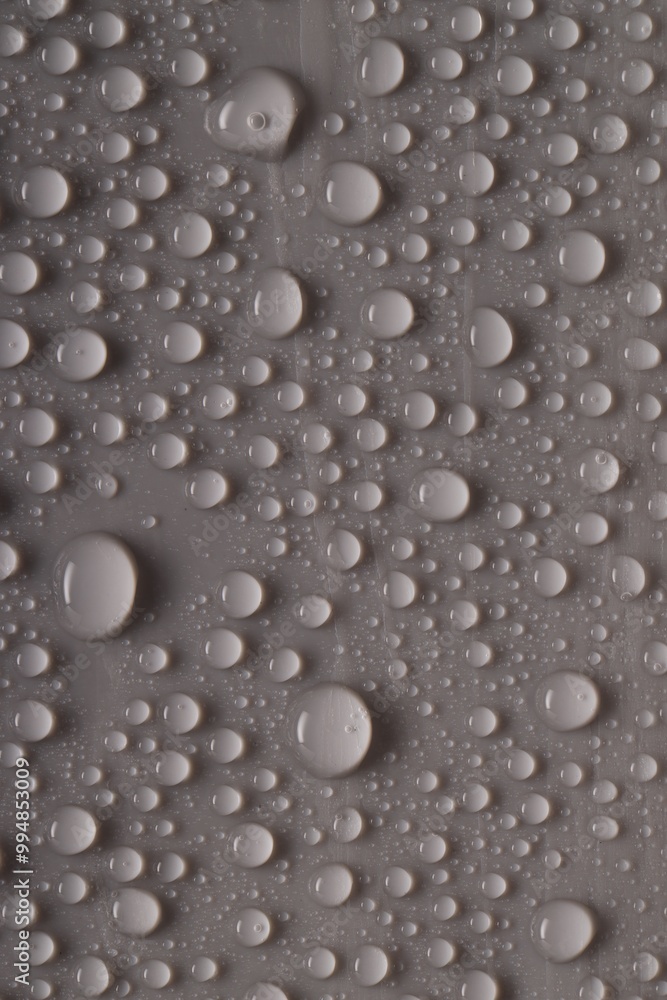 Fototapeta premium Water drops on gray background, top view