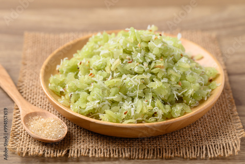 Tradition Thai dessert (Khao Mao), Green pounded unripe rice flakes with sliced coconut and sesame eating with sugar