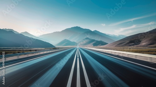 A highway with a motion blur effect leading to the horizon, mountains in the background, a blue sky, a low angle shot, a wide-angle perspective, high resolution photography, natural light, neutral col photo