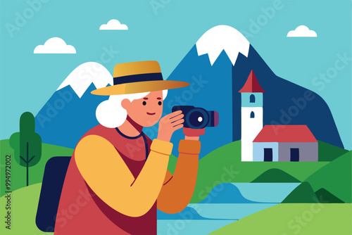 A retired woman in a hat captures photos of a small church with mountains in the background.