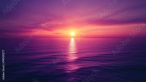 Fototapeta Naklejka Na Ścianę i Meble -  A purple sunset over the ocean, casting a warm glow over the water and sky, creating a serene atmosphere.