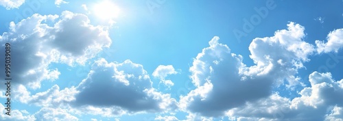 Bright Blue Sky with Fluffy White Cumulus Clouds and Radiant Sunlight