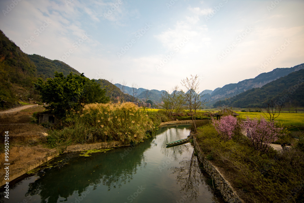 An ancient village called Bamei in eastern Yunnan, China, with rapeseed flowers and terraced fields An ancient village called Bamei in eastern Yunnan, China, with rapeseed flowers and terraced fields