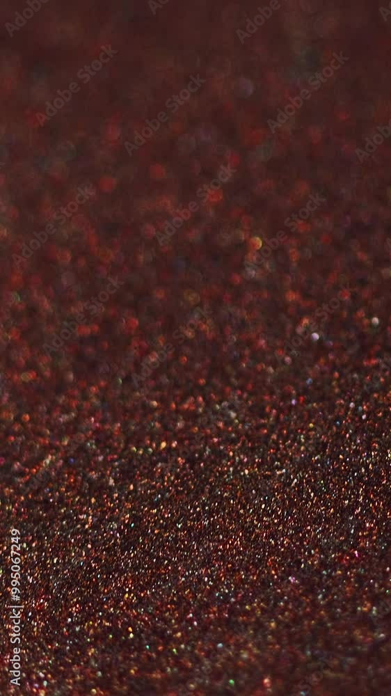 Vertical video. Glitter texture. Paint flow. Defocused red bronze golden color glowing shimmering particles bokeh light ink motion abstract art background. Vertical video. Glitter texture. Paint flow. Defocused red bronze golden color glowing shimmering particles bokeh light ink motion abstract art background.