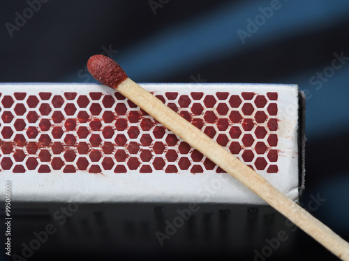 A match and the side of a  match box photo