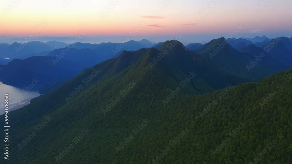 Flying over the beautiful panorama of mountain ranges at dusk. Flying over the beautiful panorama of mountain ranges at dusk.