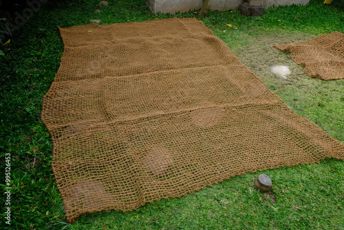 Jaring sabut kelapa, coconut coir net. made of woven coconut coir rope. This net is useful for mine reclamation and reclamation of the environment damaged by humans. geo textile.  photo