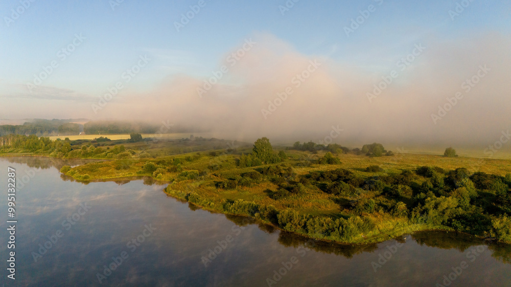 Fog rises from the lake at dawn Fog rises from the lake at dawn