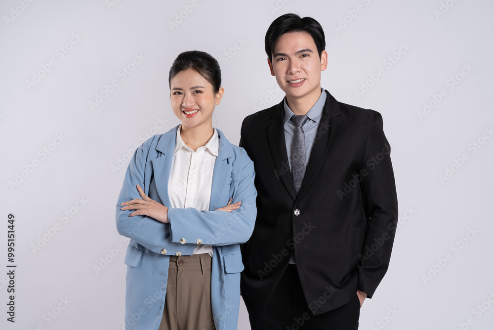 Image of an Asian business couple posing on a white background. Image of an Asian business couple posing on a white background.