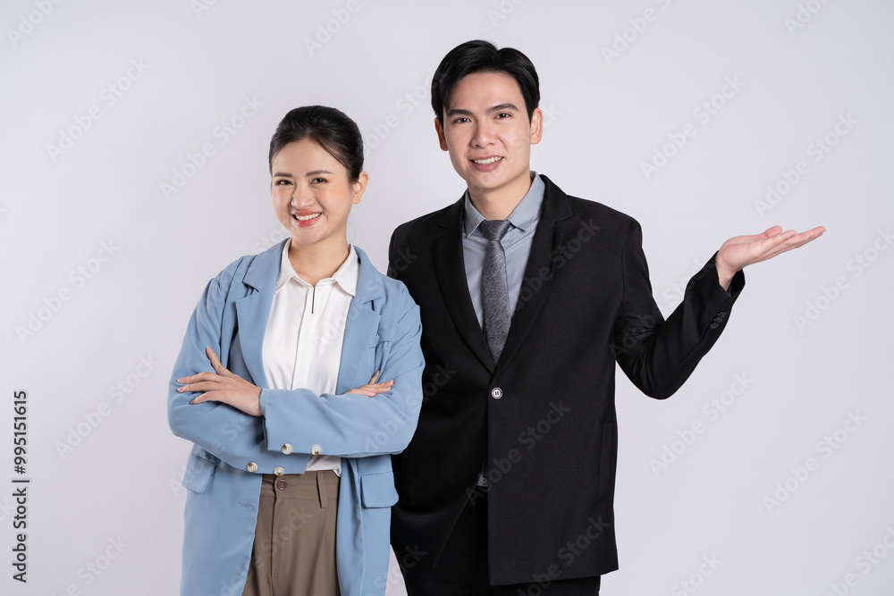 Image of an Asian business couple posing on a white background. Image of an Asian business couple posing on a white background.