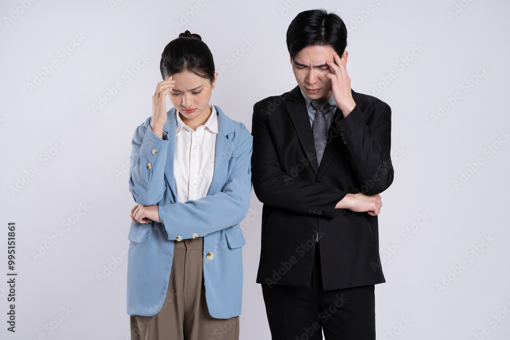 Image of an Asian business couple posing on a white background.